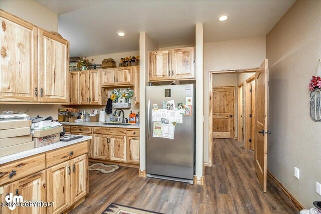 18226 Guernsey Rd, Wasilla, AK 99654 - kitchen with dark wood-style flooring, light countertops, light brown cabinets, a sink, and freestanding refrigerator