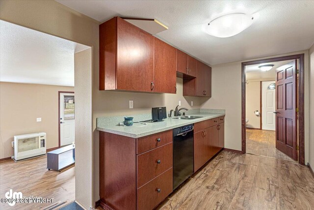 18226 Guernsey Rd, Wasilla, AK 99654 - kitchen with black dishwasher, light countertops, light wood-style floors, and a sink