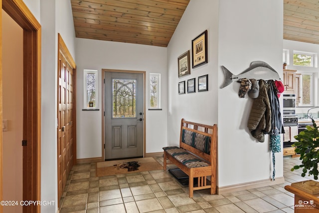 tiled entrance foyer featuring vaulted ceiling, wooden ceiling, and sink