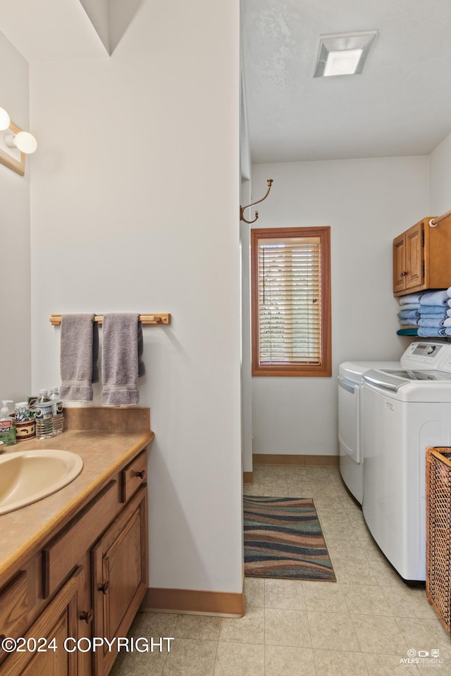 washroom with washing machine and clothes dryer and sink