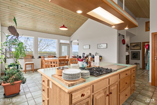 kitchen featuring light brown cabinetry, wood ceiling, high vaulted ceiling, a kitchen island, and light tile patterned flooring