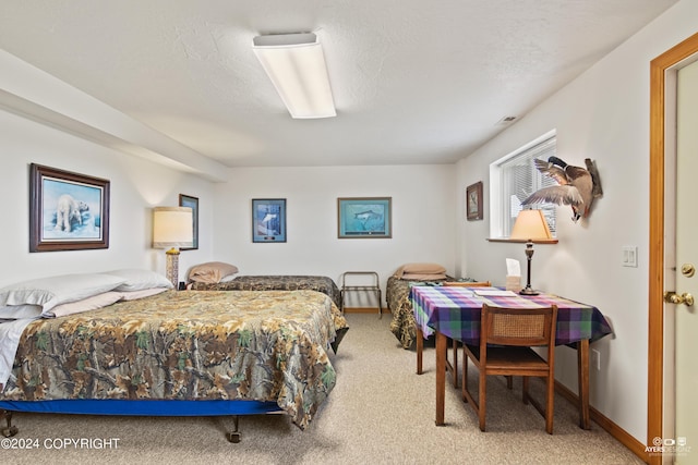 carpeted bedroom featuring a textured ceiling