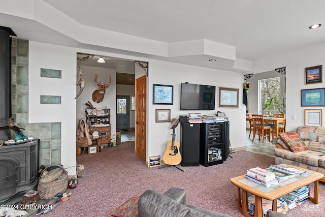 living room with a wood stove and carpet