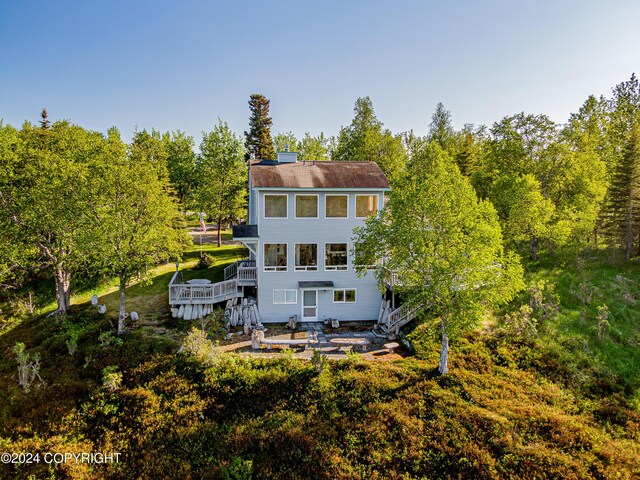 back of house with a wooden deck