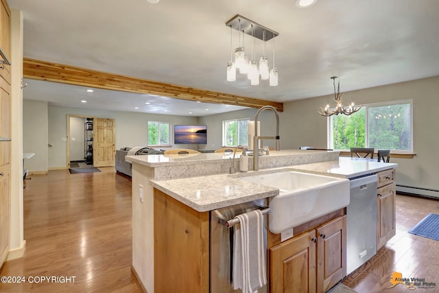 kitchen featuring sink, hanging light fixtures, dishwasher, an island with sink, and light stone countertops