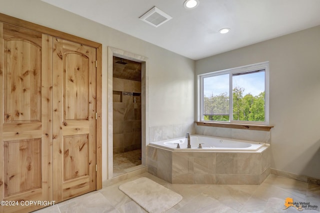 bathroom with shower with separate bathtub