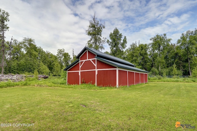 view of outbuilding with a yard