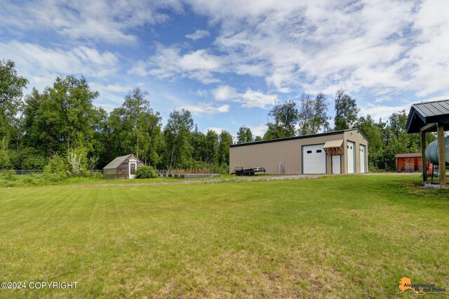 view of yard with an outbuilding and a garage