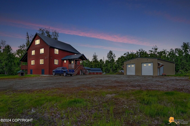 exterior space with a garage and an outbuilding