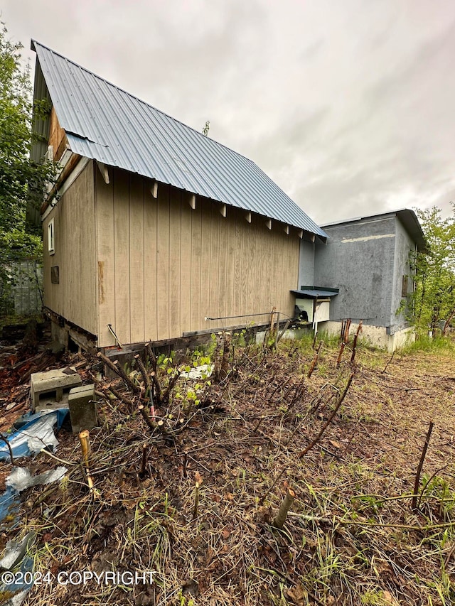 view of property exterior featuring an outdoor structure