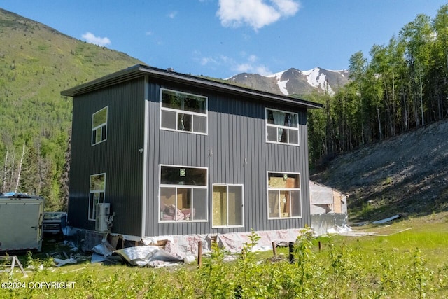 back of property featuring a mountain view