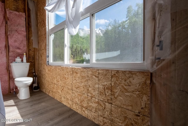 bathroom featuring hardwood / wood-style floors, toilet, and a wealth of natural light