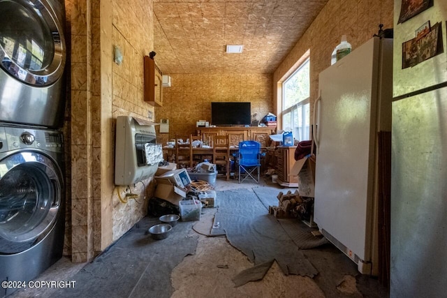 laundry room featuring stacked washer / drying machine