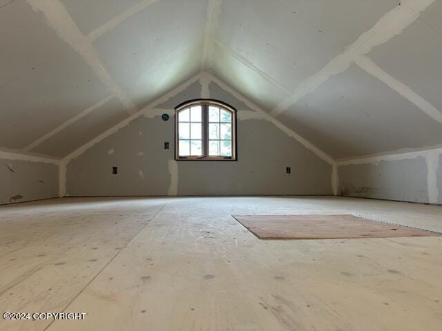 additional living space featuring vaulted ceiling