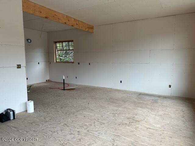 empty room with beamed ceiling