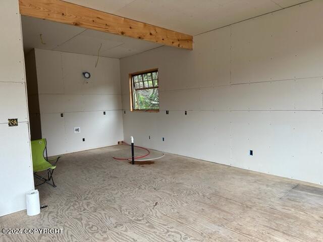 empty room with beam ceiling