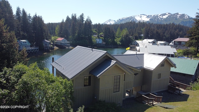 birds eye view of property with a water and mountain view