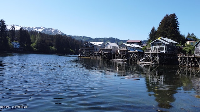 property view of water featuring a boat dock and a mountain view