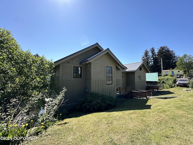 view of side of property with a lawn