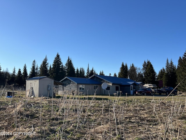 view of front of house with a storage shed