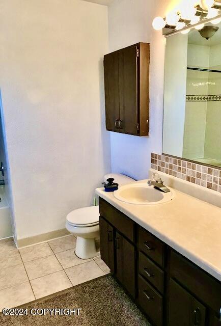 full bathroom featuring backsplash, tile patterned floors, vanity, shower / tub combination, and toilet