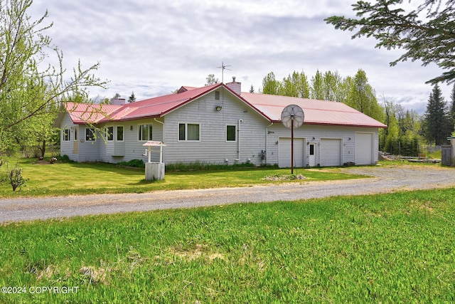 view of front of house featuring a garage and a front yard