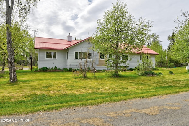 view of side of property with a lawn