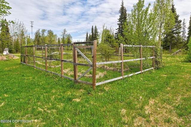 view of gate with a rural view