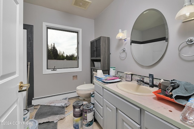 bathroom featuring vanity, walk in shower, toilet, and baseboard heating