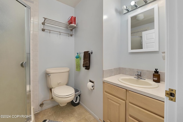 bathroom with vanity, toilet, tile patterned flooring, and a shower with door