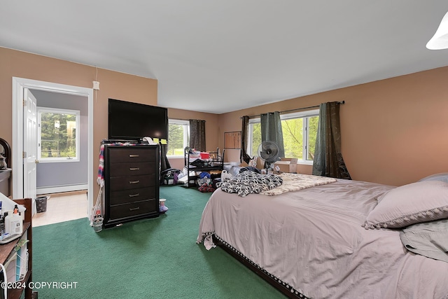 bedroom featuring baseboard heating and dark carpet