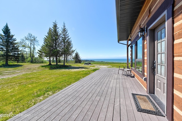 deck featuring a yard and a water view