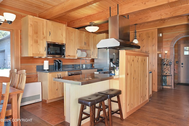 kitchen with island range hood, light brown cabinets, beamed ceiling, and stainless steel appliances