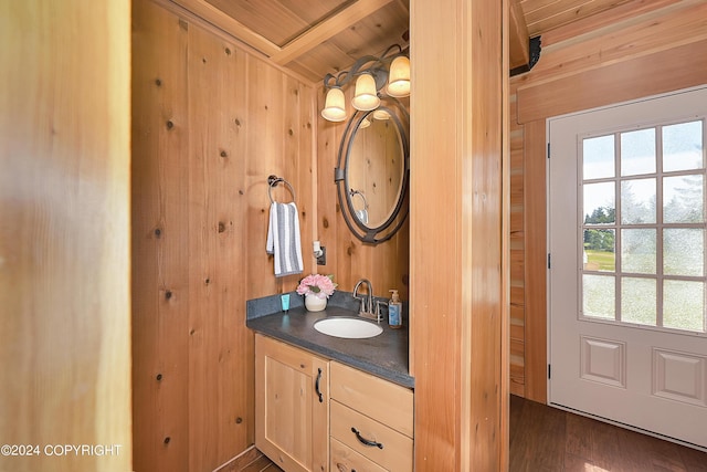 bathroom with vanity, wood walls, and wood ceiling