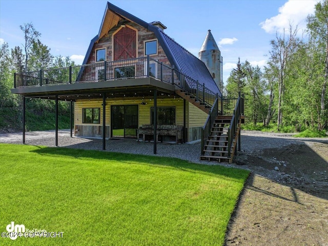 back of house featuring a yard, a patio, and a wooden deck