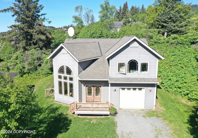 view of front of property featuring a garage and a front lawn