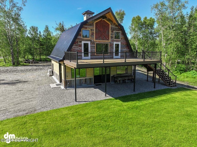 back of house with a yard, a patio, and a wooden deck