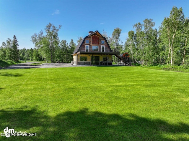 rear view of house featuring a lawn