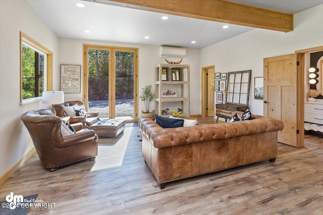 living room featuring a wall mounted AC, light hardwood / wood-style flooring, and beamed ceiling