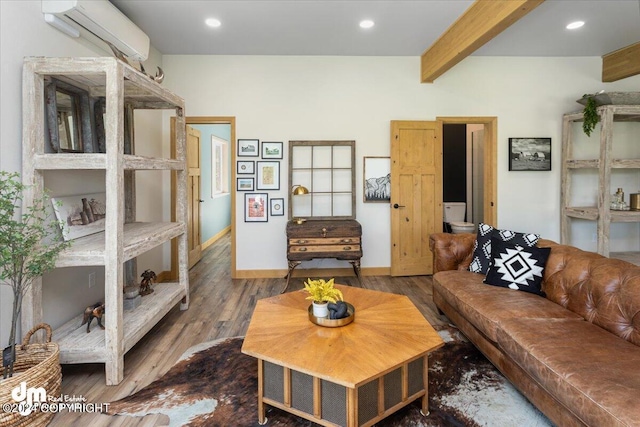 living room featuring beam ceiling, dark hardwood / wood-style flooring, and a wall mounted AC