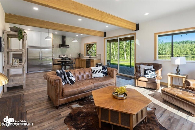 living room with beam ceiling, sink, and dark wood-type flooring