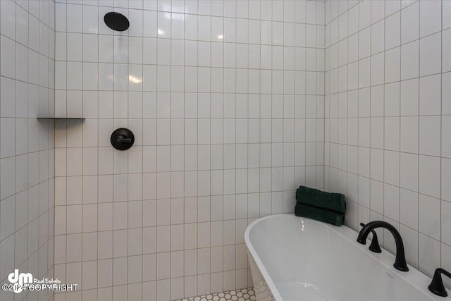 bathroom featuring a tub to relax in and tile walls