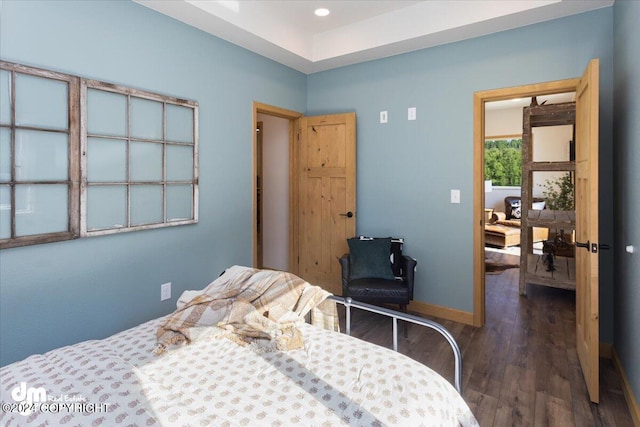 bedroom with dark wood-type flooring