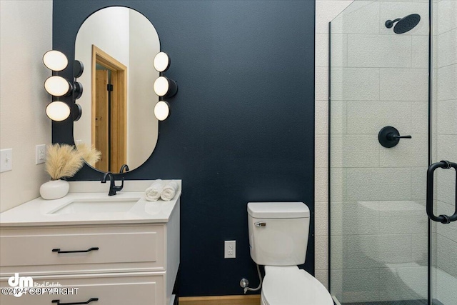 bathroom featuring vanity, toilet, and a shower with door