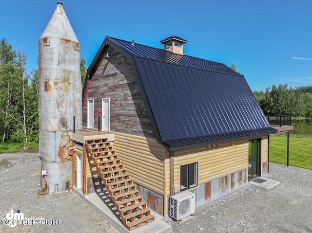 view of side of home with ac unit