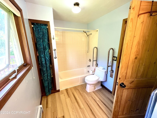 17041 Jacqueline Cir, Anchorage, AK 99516 - full bathroom with toilet, wood finished floors, washtub / shower combination, a baseboard radiator, and baseboards