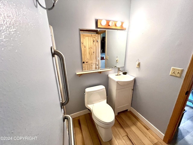 17041 Jacqueline Cir, Anchorage, AK 99516 - bathroom with wood finished floors, vanity, baseboards, and toilet
