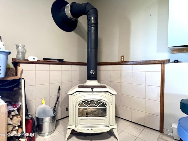 17041 Jacqueline Cir, Anchorage, AK 99516 - detailed view of tile walls, a wood stove, and wainscoting