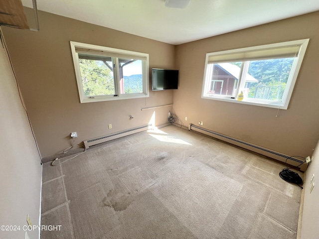 17041 Jacqueline Cir, Anchorage, AK 99516 - spare room featuring plenty of natural light, a baseboard radiator, and carpet
