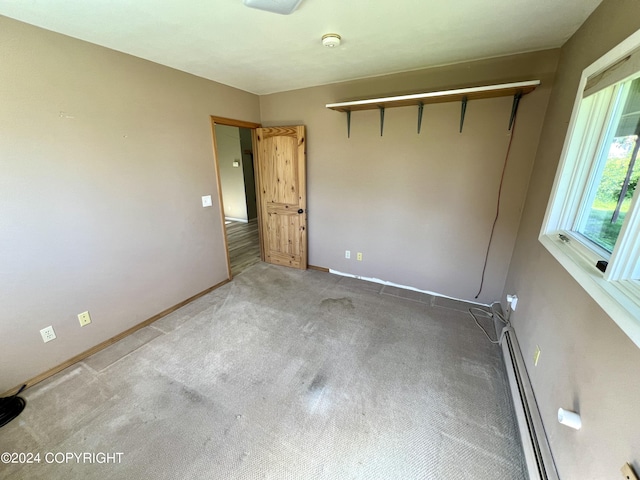 17041 Jacqueline Cir, Anchorage, AK 99516 - spare room featuring baseboards, carpet flooring, a smoke detector, and a baseboard heating unit
